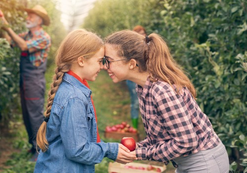 Sisters enjoying their time apple picking at an apple orchard in Illinois