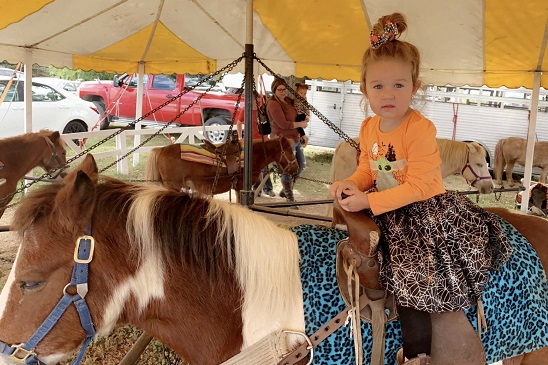 A young girls rides a pony at Tanners Orchard, which is just one of the options available at our Apple Orchard for Joliet IL residents