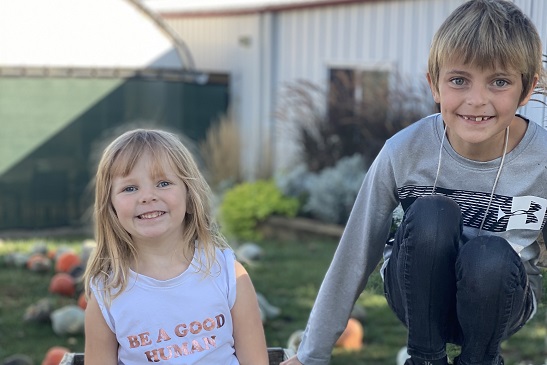 A brother and sister smile at the camera while enjoying all of the Fall Activities for Joliet IL residents that Tanners Orchard has to offer