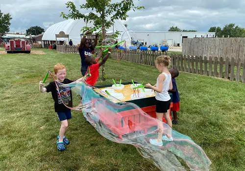 Kids play with bubbles at Tanners Orchard, an Apple Orchard by Champaign IL